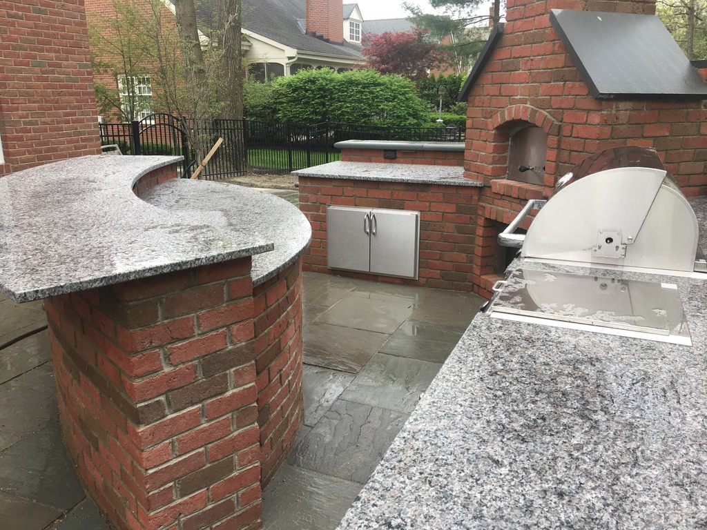 Is granite or quartz better for outdoor kitchens?